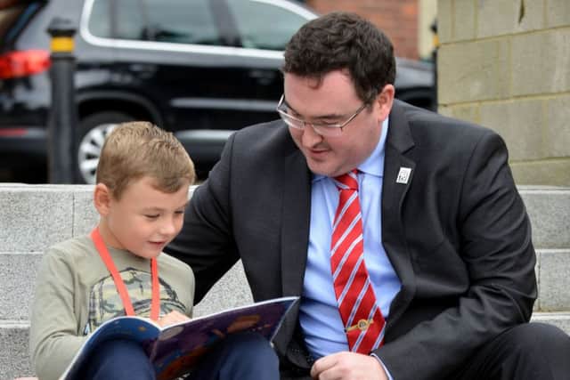 Hartlepool Borough councillor Michael McLaughlin reads with Max Hussey after he presented him with a reading certificate and medal. Picture by FRANK REID