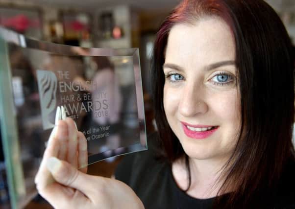 Samantha Lewis from Silhouette with one of their past awards. Picture by FRANK REID