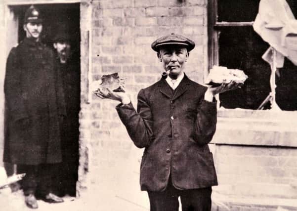 A resident with some of the damage caused by a 12-in shell in West Hartlepool during the bombardment of the town in 1914.