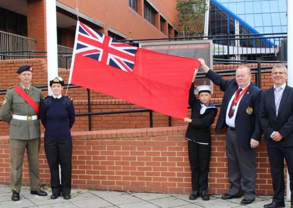 Colour Sergeant Paul Hume, Sub-Lieutenant Nicola Robinson, Cadet Lewis Dawes, Councillor Allan Barclay, and Chris Little with the Red Ensign.