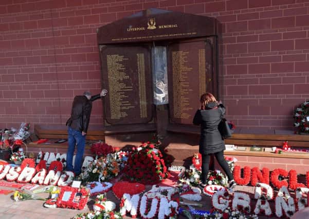 Fans pay their respects at the Hillsborough memorial at Anfield earlier this year.