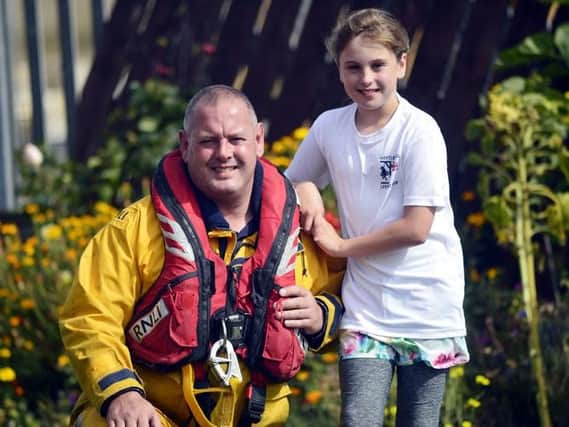 Millie Crangle with her dad Mark. Picture credit: RNLI/Tom Collins