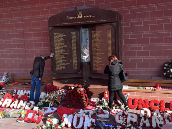 Fans pay their respects at the Hillsborough memorial at Anfield. Picture: Anthony Devlin/PA Wire.