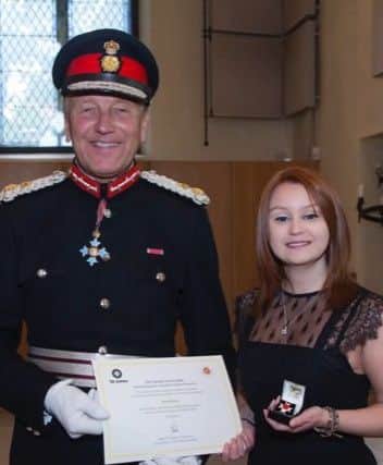 Gemma McLean accepting an Order of St John award in honour of dad Alan's organ donation.