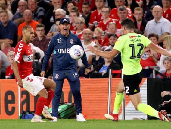 Middlesbrough manager Tony Pulis watches Martin Braithwaite and John Egan compete for the ball
