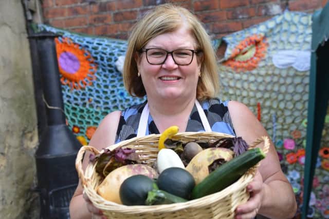 Jane Johnson  with fresh produce at the new St Mary's community garden.