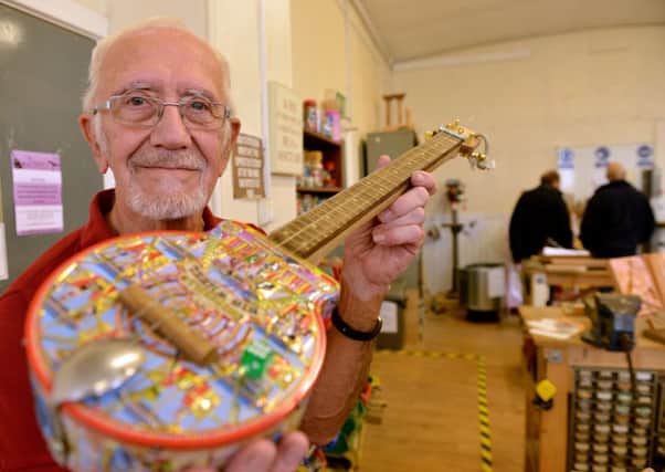 Mike Burton with one of the many guitars he designed and made at the Hartlepool Men's Shed. Picture by Frank Reid