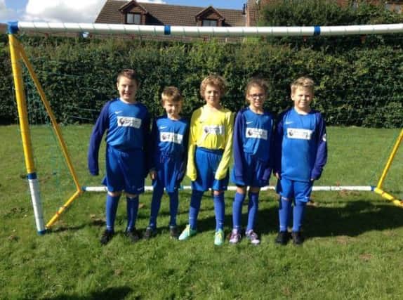 Pupils from St. Peters Elwick CE VA modelling the new Premier League kit.