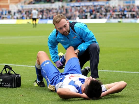 Ryan Donaldson receives treatment on the sidelines on Saturday.