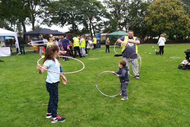 Children learning circus hoop skills.