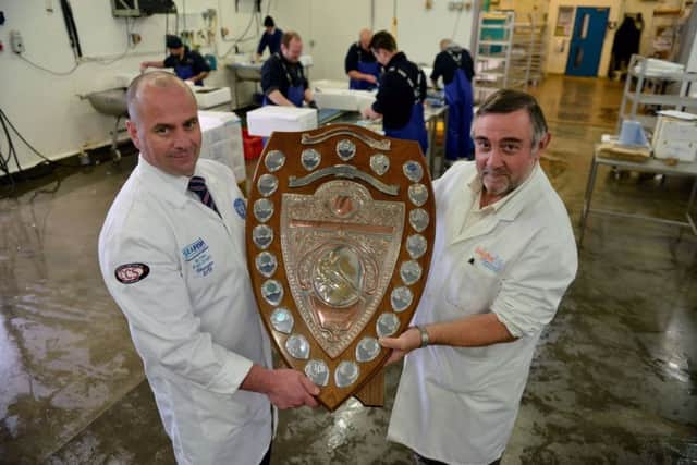Fishmonger of the year Alan Barker from Hodgson Fish (left) is presented with his shield by Alan Hodgson. Picture by FRANK REID