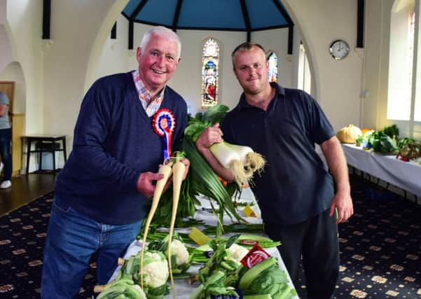 Dave Collin (left) with his prize winning parsnips and Danny Potter with his first placed leeks at the Hutton Henry Flower and Veg Show at St Francis Village Hall.