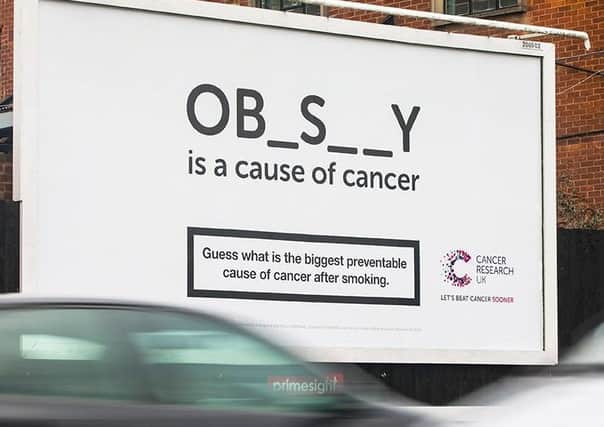 Cancer Research UK billboard.