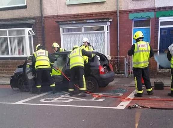 Firefighters work to free a driver from a Renualt Clio following a crash in Brenda Road. Picture by Artur Makowski.