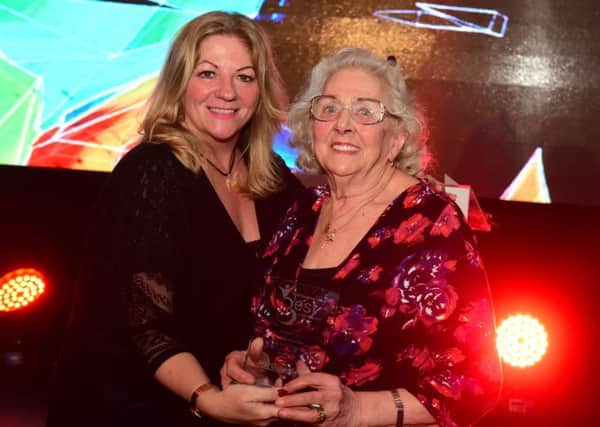 Lifetime Achievement award winner Edith Harrison receives her award from Editorial Director Joy Yates.
