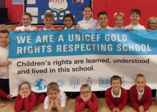 Shotton Hall Primary School pupils with their UNICEF banner after achiving Gold Status in its Rights Respecting Schools Award.