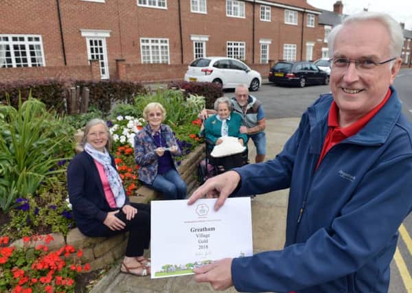 Brian Walker, Chairman of Greatham in Bloom, holding their gold Northumbria in Bloom certificate with fellow members (left to right) Hazel Campbell, Ann Murray, Dorothy Clark and Peter Dixon in front of their flowerbed designed in tribute to the RAF's centenary. Picture by Frank Reid.