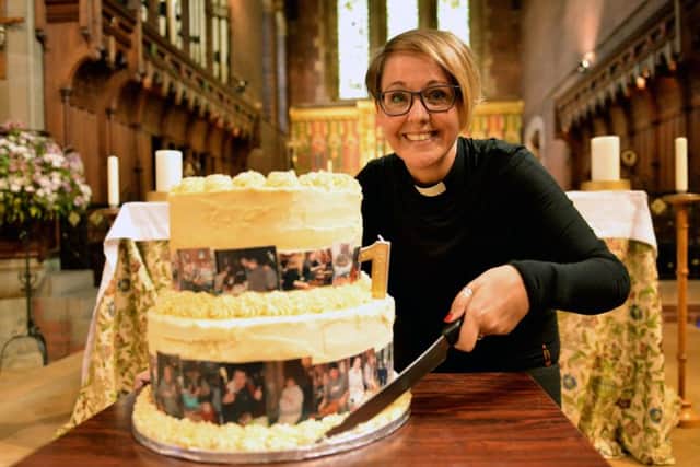 Rev Gemma Sampson cutting a cake at St. Aidan's Church to celebrate the first year of the food kitchen.