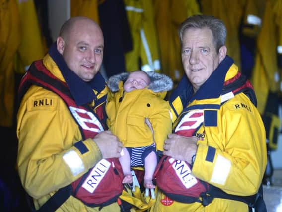 Liam Dunnett with dad Steve and baby Arthur at the Ferry Road lifeboat station. Photo by Tom Colins/RNLI.