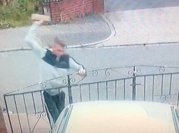 Male who smashed a car window with a brick.