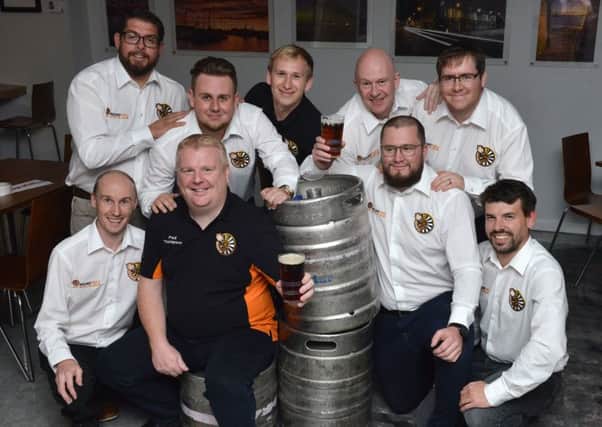 Hartlepool Round Table chairman Paul Thompson (front second left) holding a pint of the Hartlepool Mail sponsored beer Trespass Porter with fellow Hartlepool Round Table members. Picture by Frank Reid.