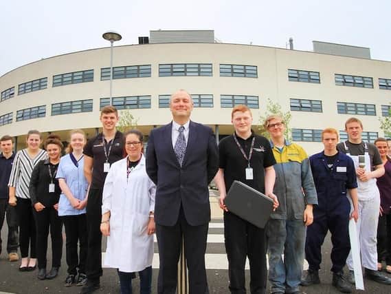 Darren Hankey outside Hartlepool College of Further Education with students.