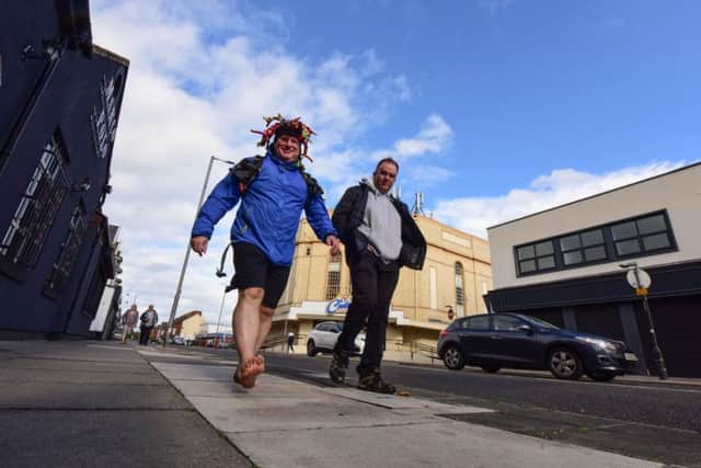 Paul Suggitt (left) walking barefoot around the town in training for a barefoot challenge he is doing next year, accompanied on Saturday by Ian Bushnell