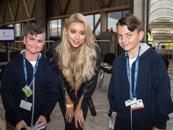 Una Healy from The Saturdays meets Isaac Atyeo (left), from Hartlepool and Cole Taylor from Newcastle at Heathrow Airport ahead of the annual Dreamflight holiday of a lifetime. Picture: PA.