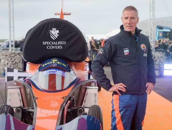 Pilot Andy Green stands beside the Bloodhound 1,000mph supersonic racing car before its first public run at Cornwall Airport, near Newquay. Picture: Ben Birchall/PA Wire.