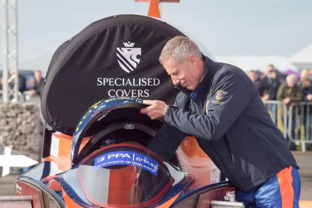Pilot Andy Green removes the cockpit canopy on the Bloodhound 1,000mph supersonic racing car before its first public run at Cornwall Airport, near Newquay. Picture: Ben Birchall/PA Wire.
