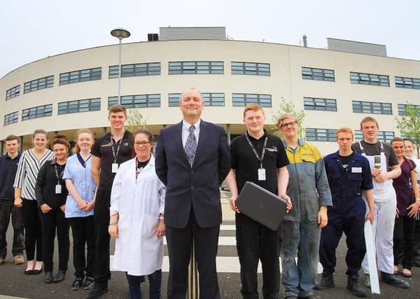 Darren Hankey outside Hartlepool College of Further Education with students