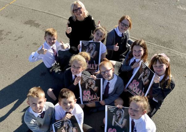 Molly Scott's mum Louise with St. Teresa's Primary school pupils as they hold the Hartlepool Mail "Go Molly" poster Picture by FRANK REID