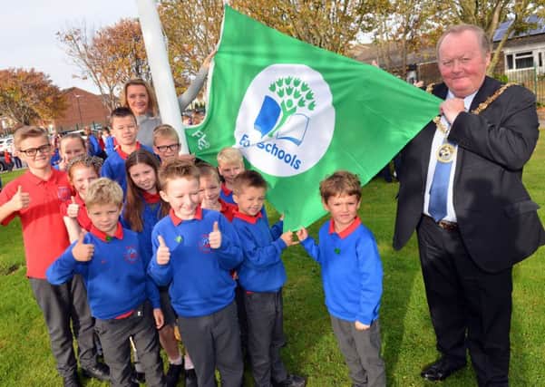 Throston Primary School eco council pupils, teacher Abby Davis and Hartlepool mayor Allan Barclay with the  Eco Schools Green Flag award.