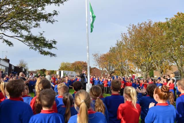 Hartlepool mayor Allan Barclay hoists the Eco Schools Green Flag award at Throston Primary School