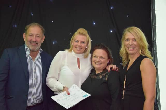 Debbie Dobson receives her award from Barchesters CEO Pete Calveley and director of regulations Sue Sheath, alongside last years winner.