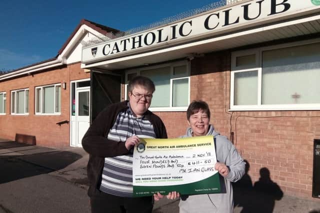 Ian Glass presents Tracy Bowstead of the Great North Air Ambulance with the money he raised from a charity night at Hartlepool Catholic Club.