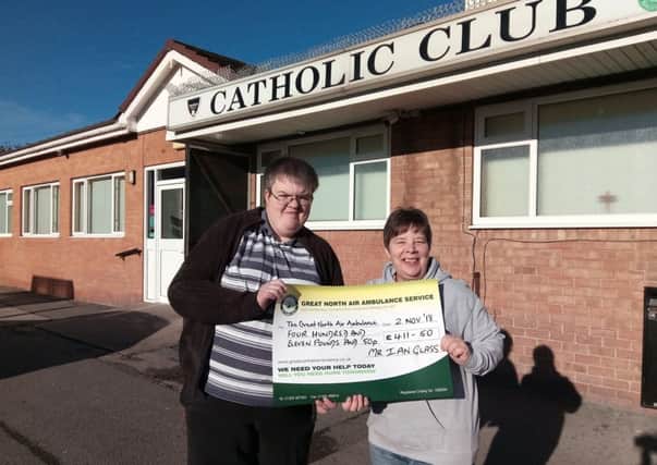 Ian Glass presents Tracy Bowstead of the Great North Air Ambulance with the money he raised from a charity night at Hartlepool Catholic Club.