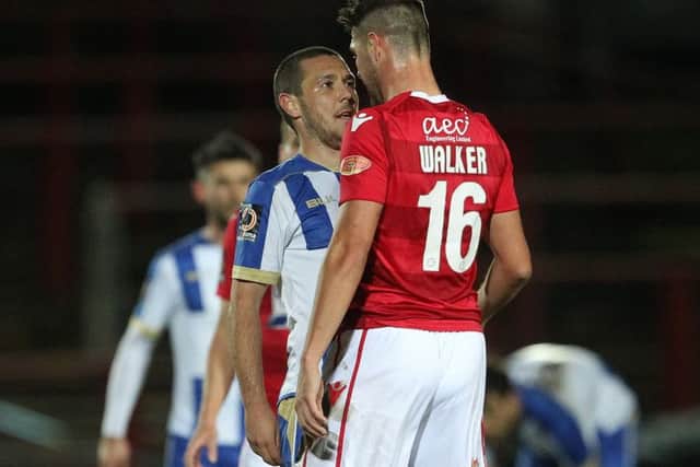 Former Hartlepool United midfielder Brad Walker clashes with Liam Noble during the game against Wrexham.