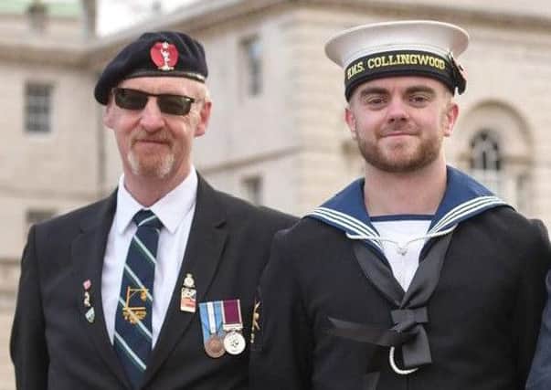 Charlie Eastwood (left) with his guide Connor Dooley at the Cenotaph in 2017.