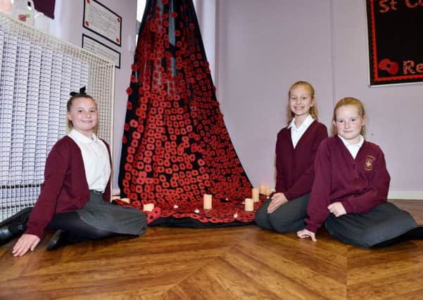 Sophie Wayper, Millie Gibson and Gabriela Ward with their cascaded Poppies on display