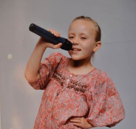 Molly Scott loved performing from a young age. Pictured aged eight.