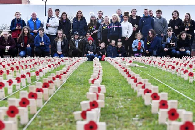 Volunteers at the Poppy Crosses event at Victory Square. Picture by