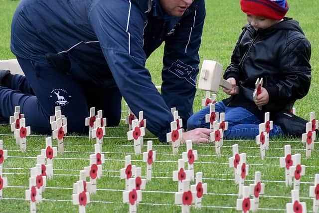 Father and son at the Poppy Crosses at Victory Square.