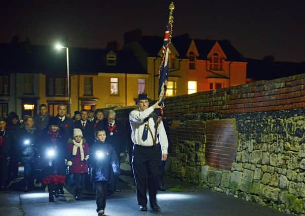 A standard bearer leads the parade from the Heugh Battery towards the Headland Beacon. Picture by Bernadette Malcolmson