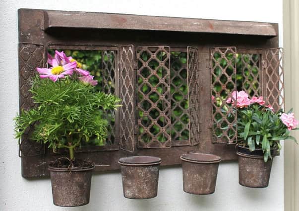 Rustic outdoor garden mirror with four planters.
