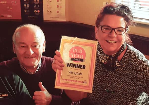 Claire Stephenson, landlady of The Globe, celebrates winning the Hartlepool Mail's Pub of the Year title for the third year in a row with customer Stan Coulson.