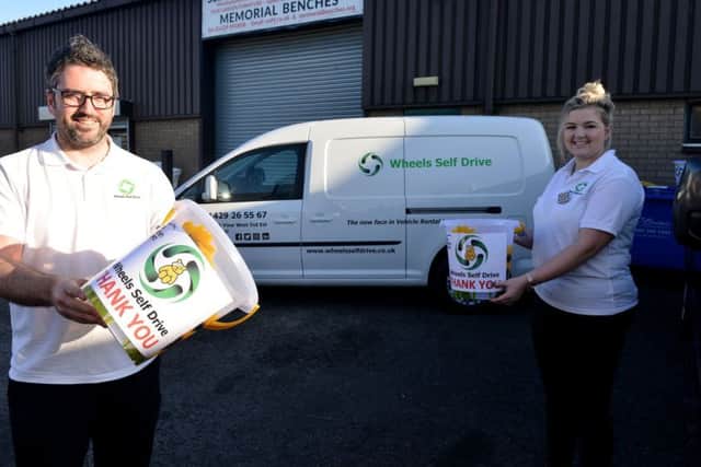 Damien and Lauren McBride from Wheels Self Hire, with their Children In Need collection buckets. Picture by FRANK REID
