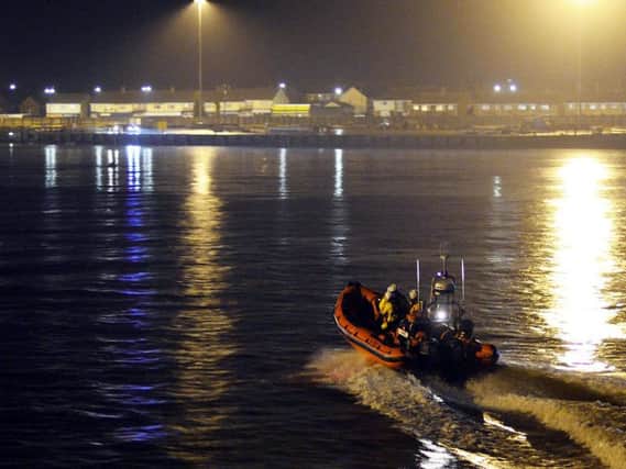 The Hartlepool RNLI inshore lifeboat heads towards Victoria Dock to search the area.