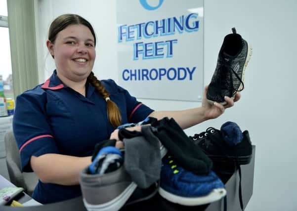 Sophie Odgers (26) owner and Podiatrist at Fetching Feet with a selection of shoes and socks