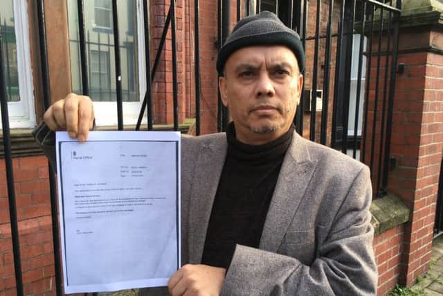 Syed Dulal with a copy of his father's visa refusal letter from the Home Office